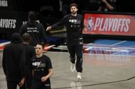 Joe Harris #12 of the Brooklyn Nets high-fives teammates